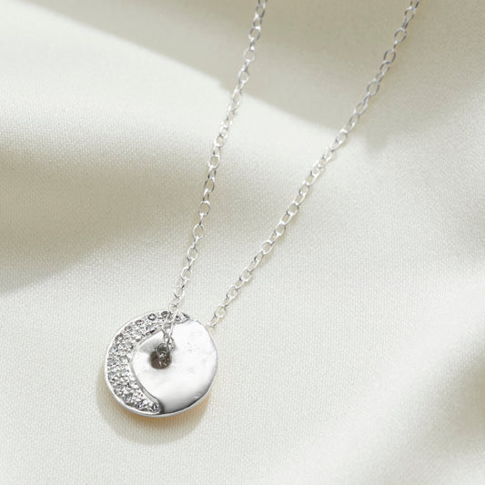 Waning crescent moon phase necklace in silver with diamonds on a elegant trace chain by Claudette Worters