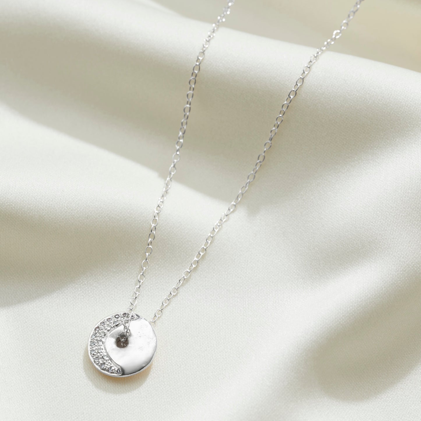 Personalised diamond crescent moon phase necklace in silver by Claudette Worters