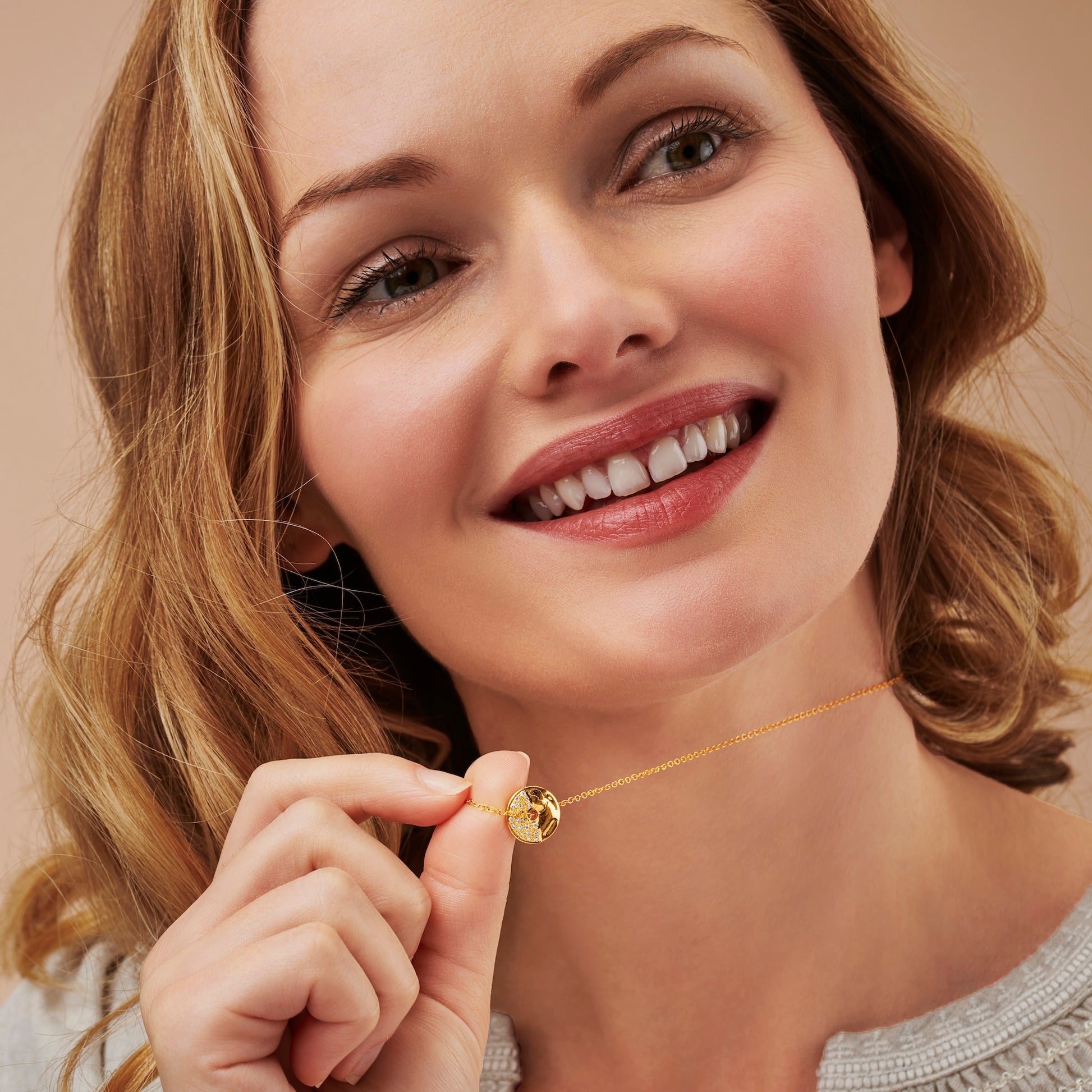 Gold vermeil Third Quarter moon necklace by Claudette Worters. A small textured gold disc pendant with tiny real diamonds set to one side, forming the third quarter shape. The chain passes through a hole in the middle of the disc so it can rotate while worn.