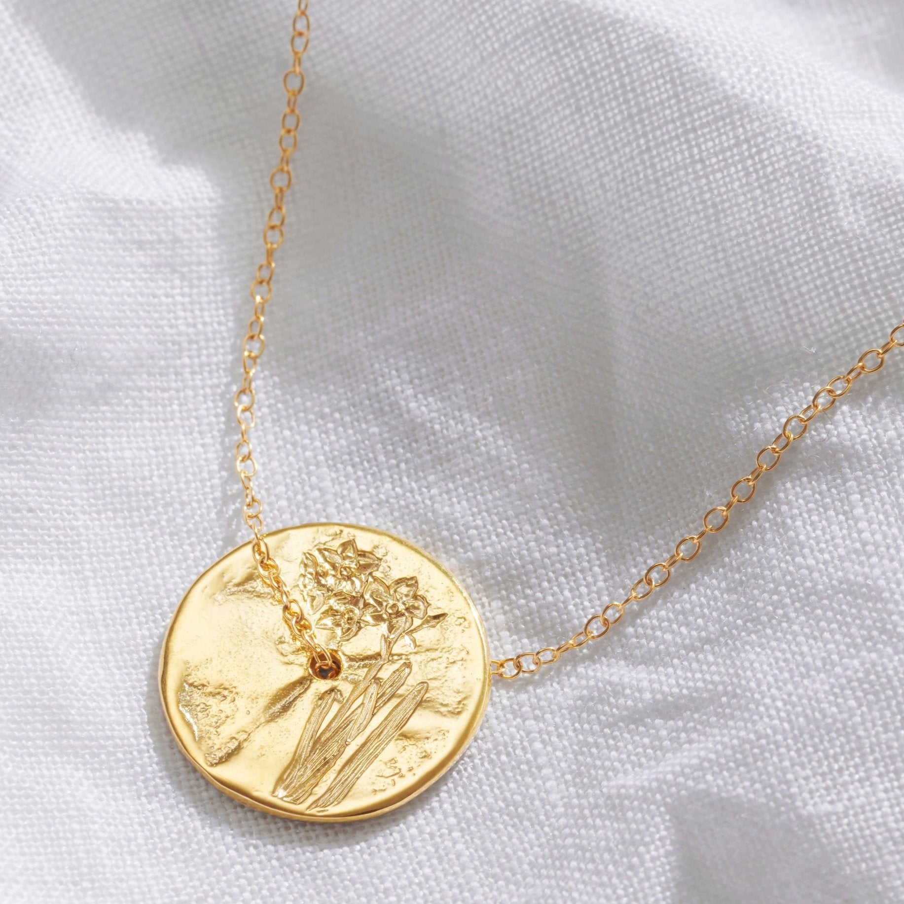 Gold disc necklace with hand engraved Narcissus flowers on a deliate gold vermeil trace chain.