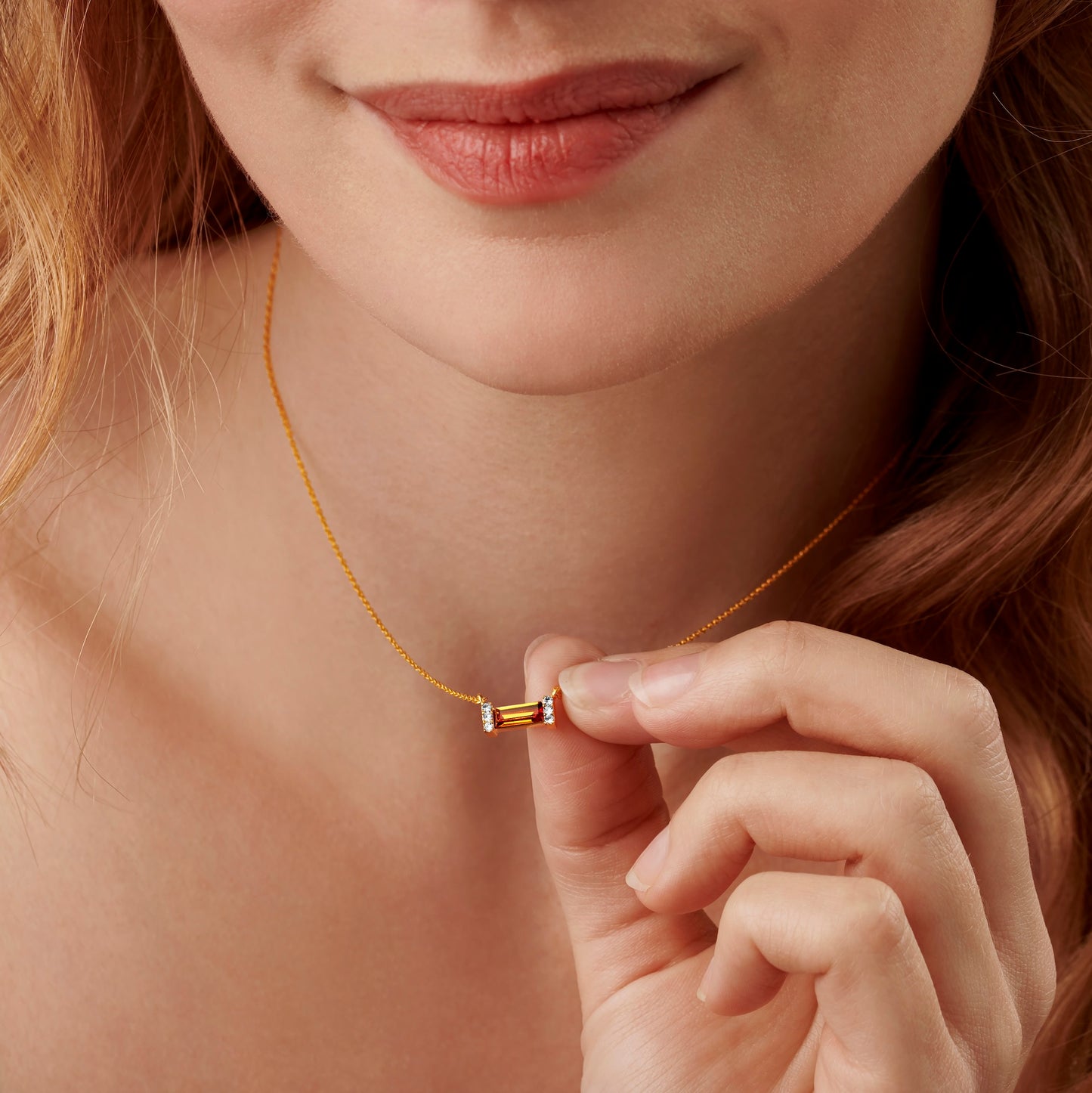 November birthstone necklace with orange Topaz on a dainty gold trace chain