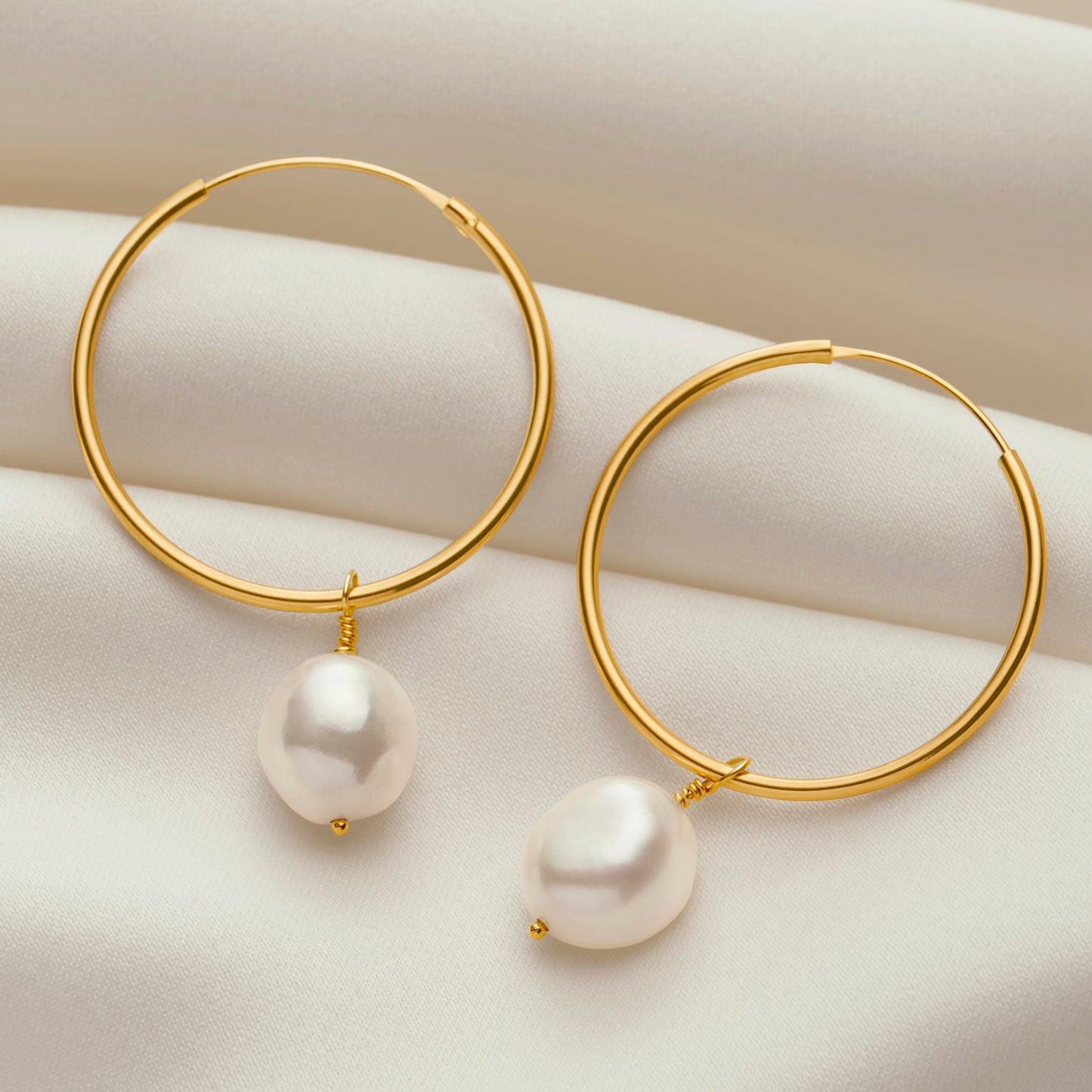 Large 9 carat gold hoop earrings with white baroque pearl