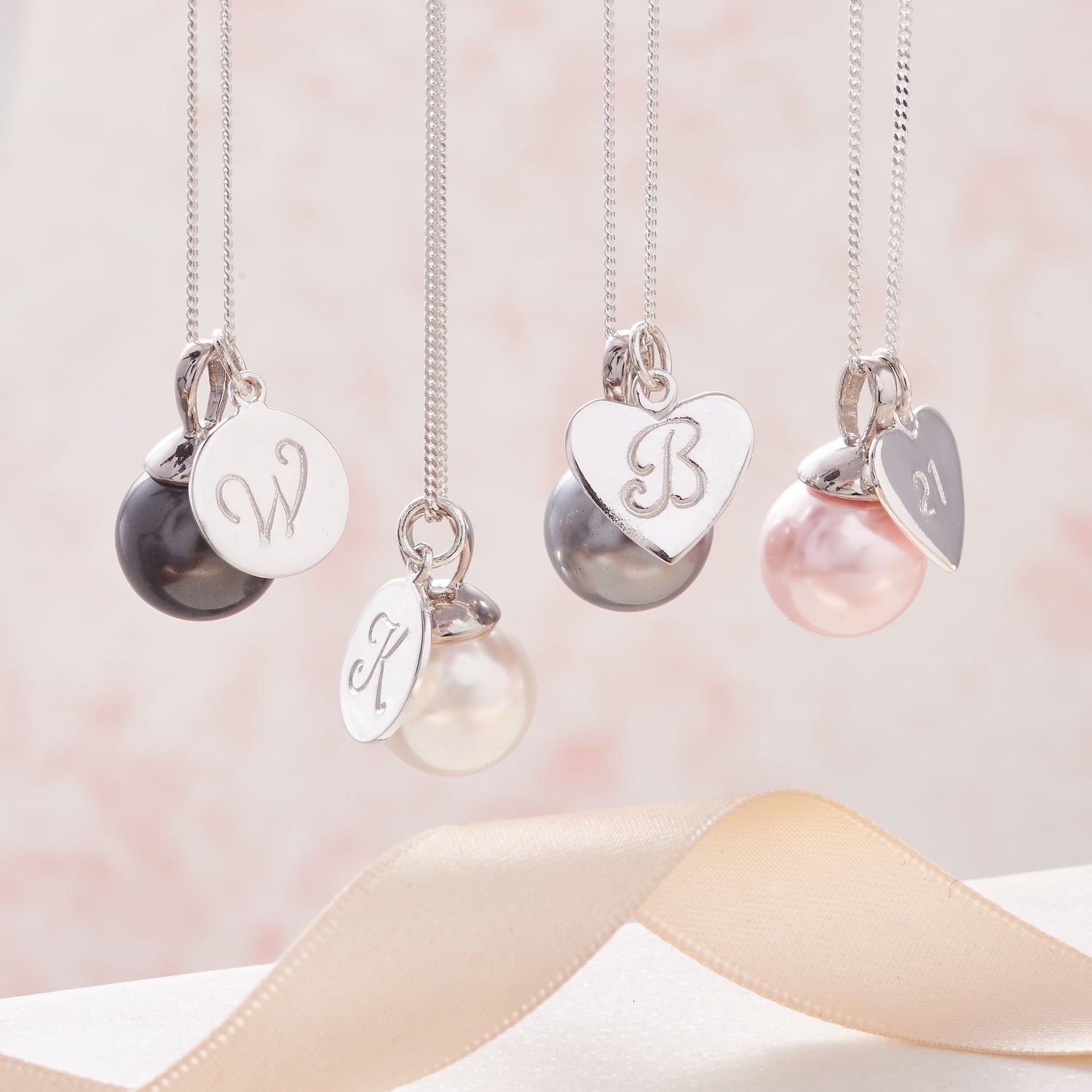 Large pearl pendant necklaces with personalised sterling silver initial charms on dainty silver chains by Claudette Worters