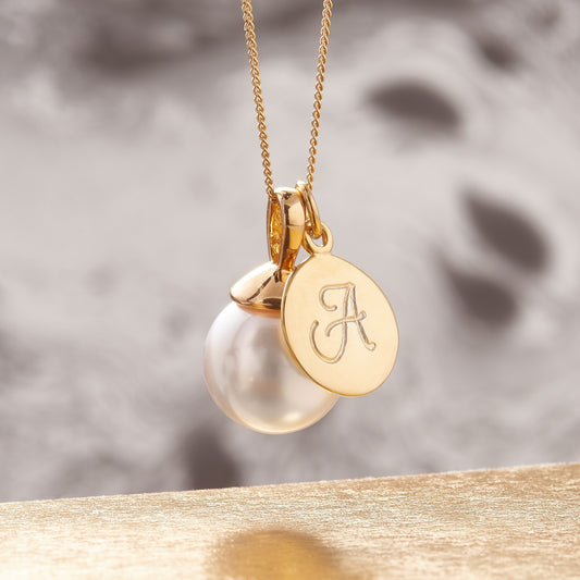 White pearl pendant in gold setting with personalised gold disc charm by Claudette Worters