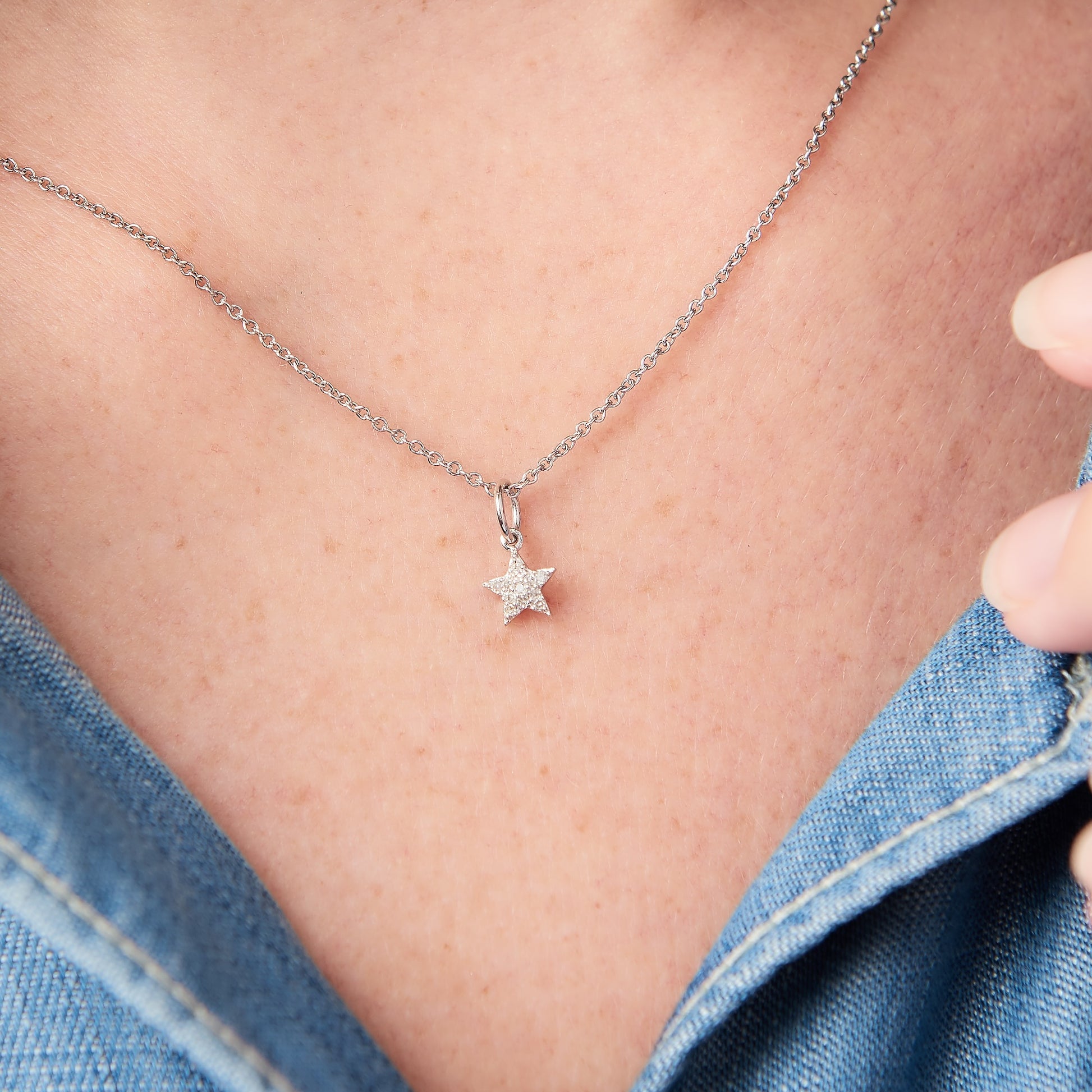 Sterling silver tiny star pendant set with tiny white diamond on a delicate sterling silver fine gauge trace chain.