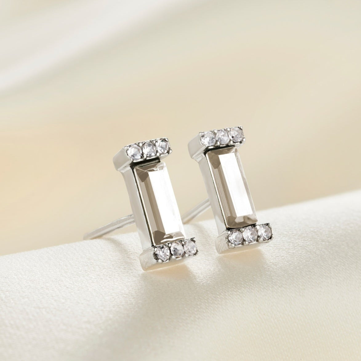 Sterling silver stud earrings with faceted clear crystal baguette stones in little pavé crystal settings. 