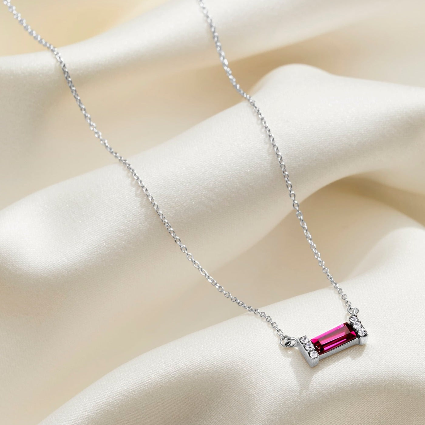 Ruby red baguette shaped crystal birthstone necklace on a delicate sterling silver trace chain. 