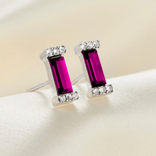 Sterling silver stud earrings with ruby coloured baguette cut crystals in pavé crystal settings.