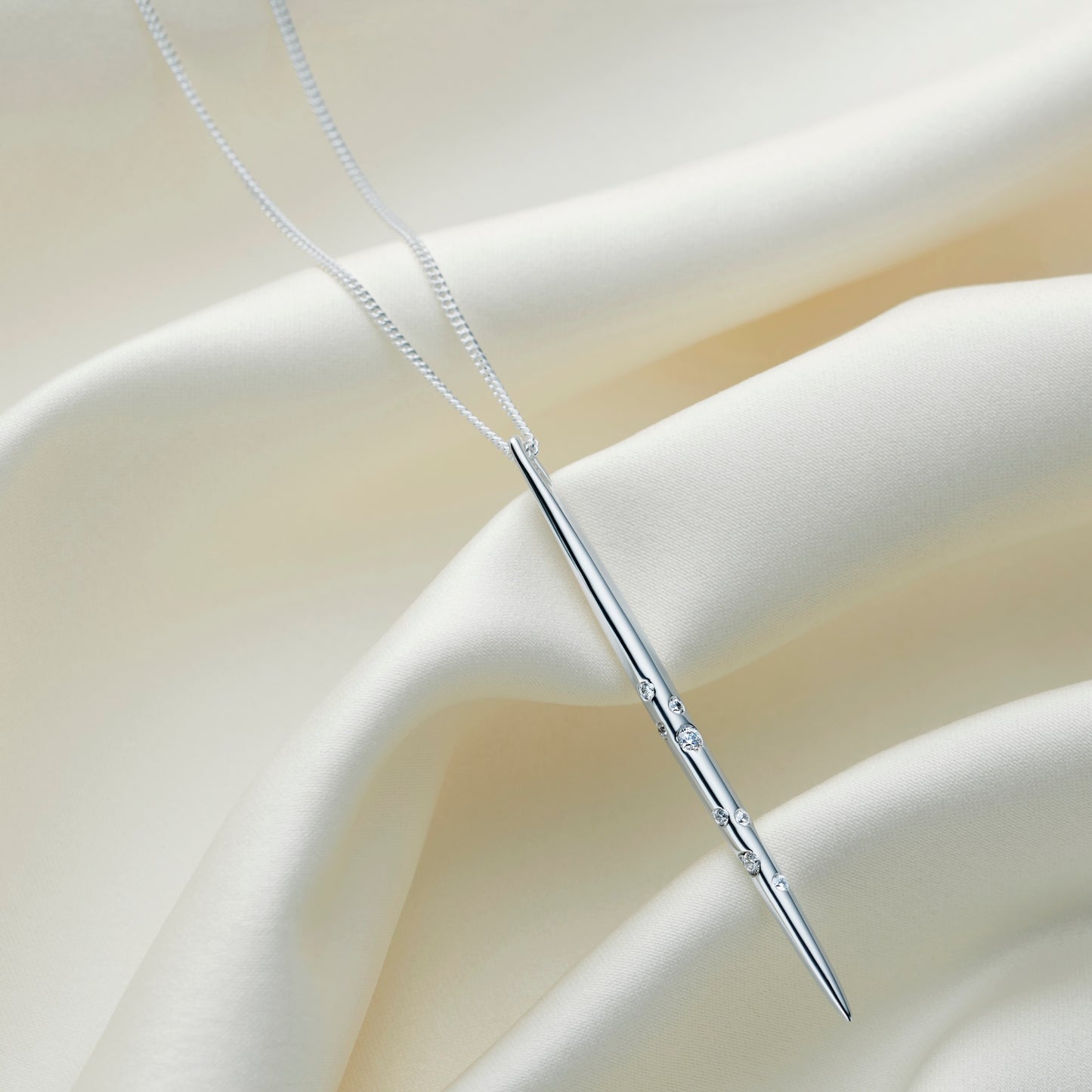 Sagittarius zodiac necklace by Claudette Worters, featuring a sleek sterling silver spike pendant with Swarovski crystals arranged in the Sagittarius constellation, finished on a fine silver chain.