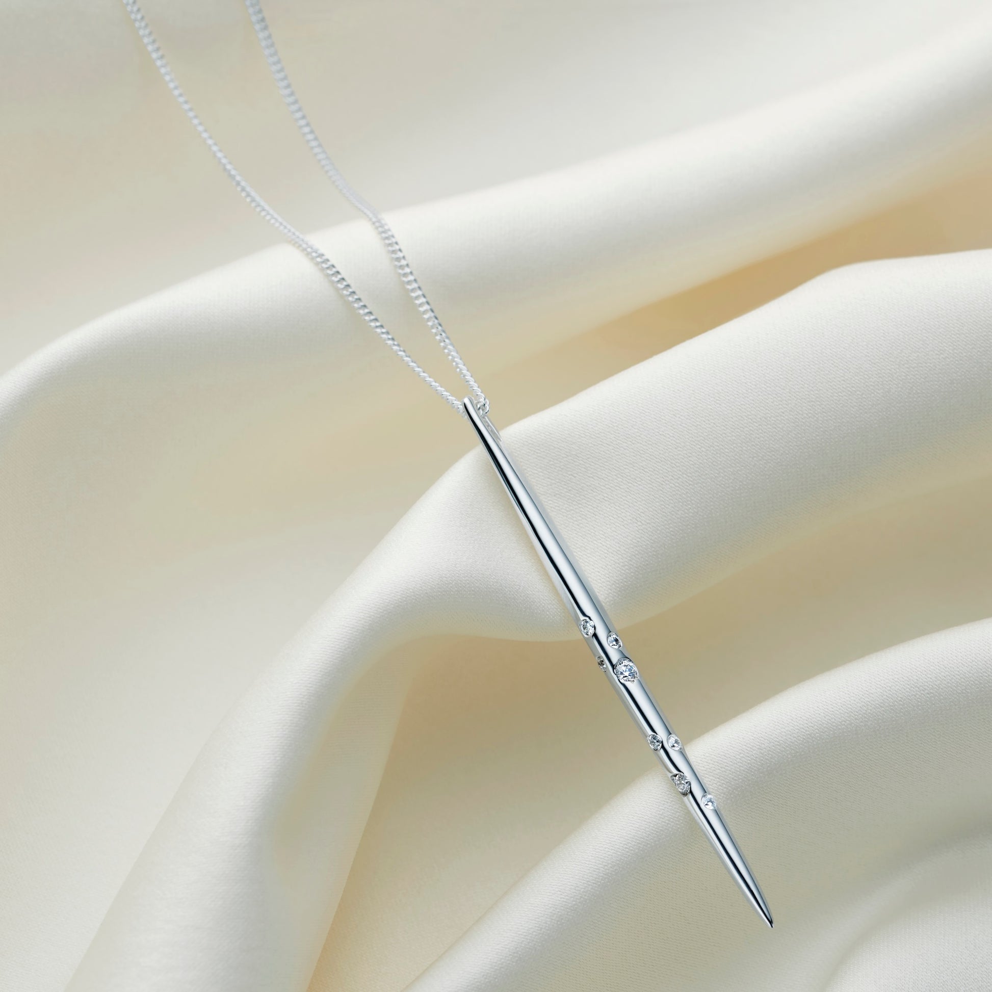 Sagittarius zodiac necklace by Claudette Worters, featuring a sleek sterling silver spike pendant with Swarovski crystals arranged in the Sagittarius constellation, finished on a fine silver chain.
