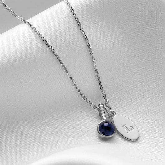 Sapphire and diamond birthstone pendant in silver with personalised initial charm 