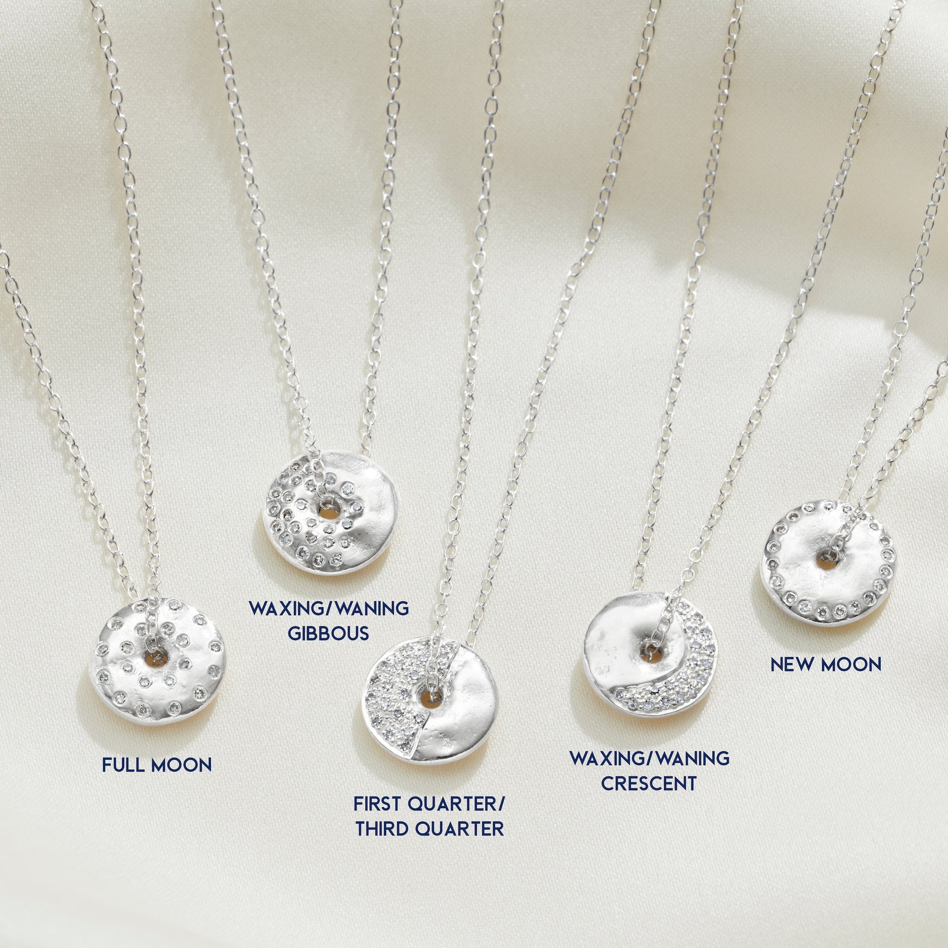 Silver necklaces with moon phase pendants  showing all 8 phases of the moon by Claudette Worters