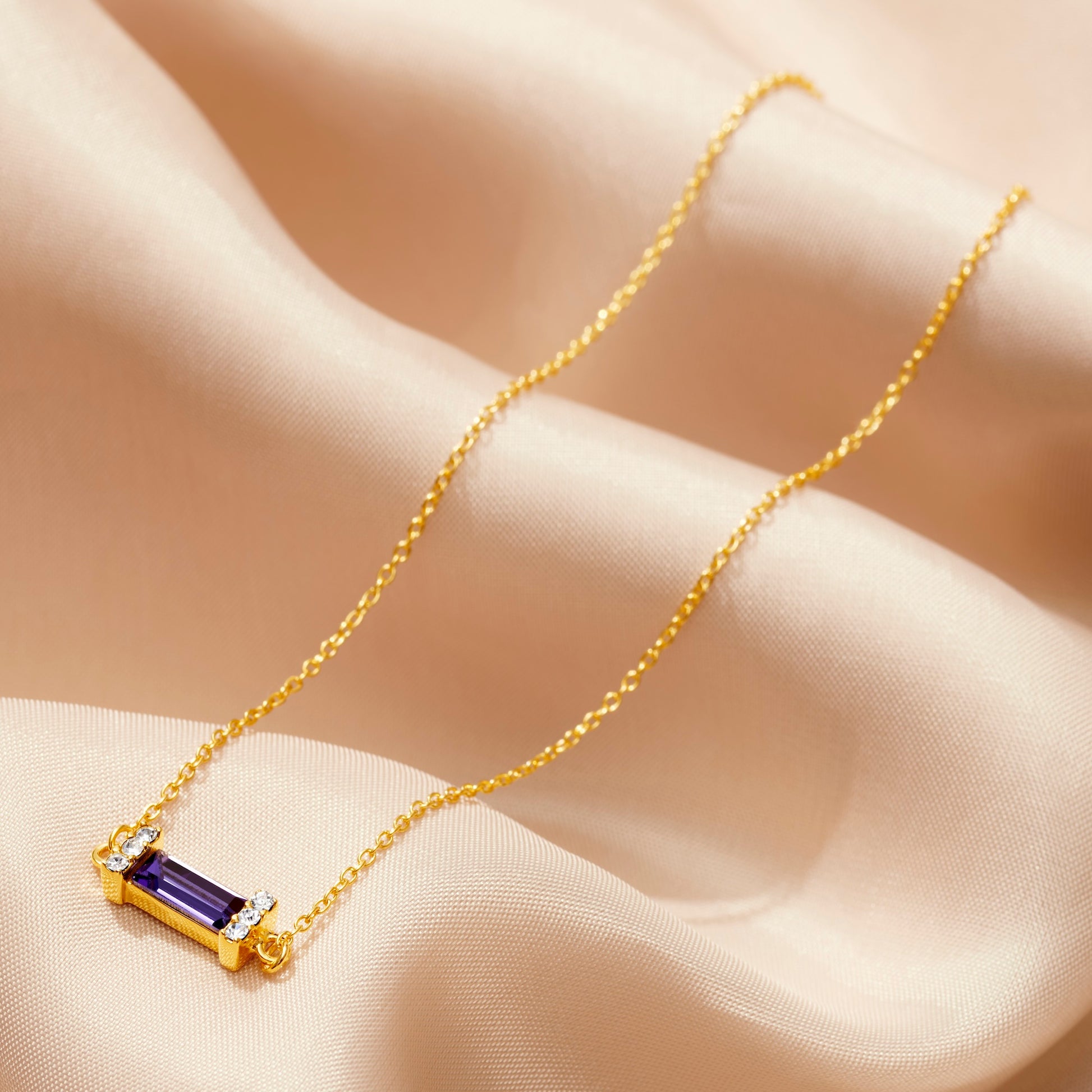 December birthstone necklace with baguette cut Tanzanite in gold vermeil