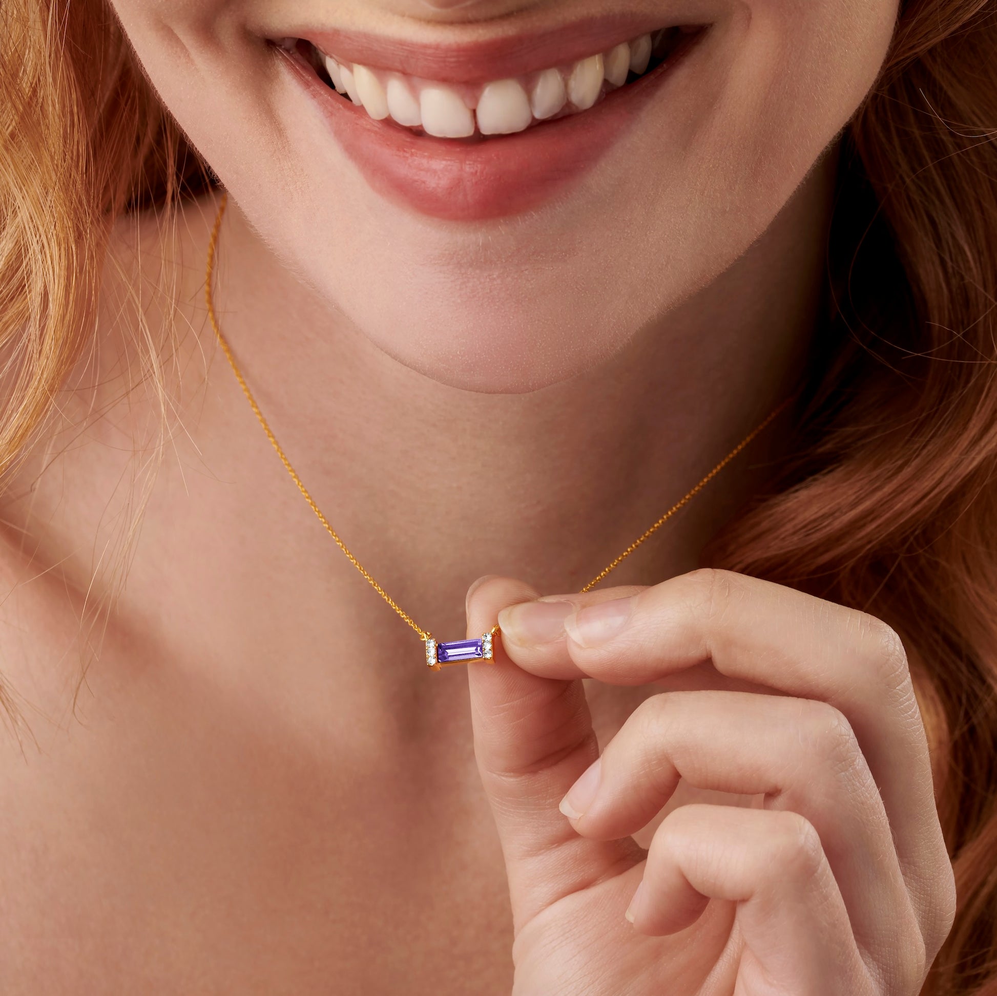 December birthstone necklace in gold with baguette cut Tanzanite gem