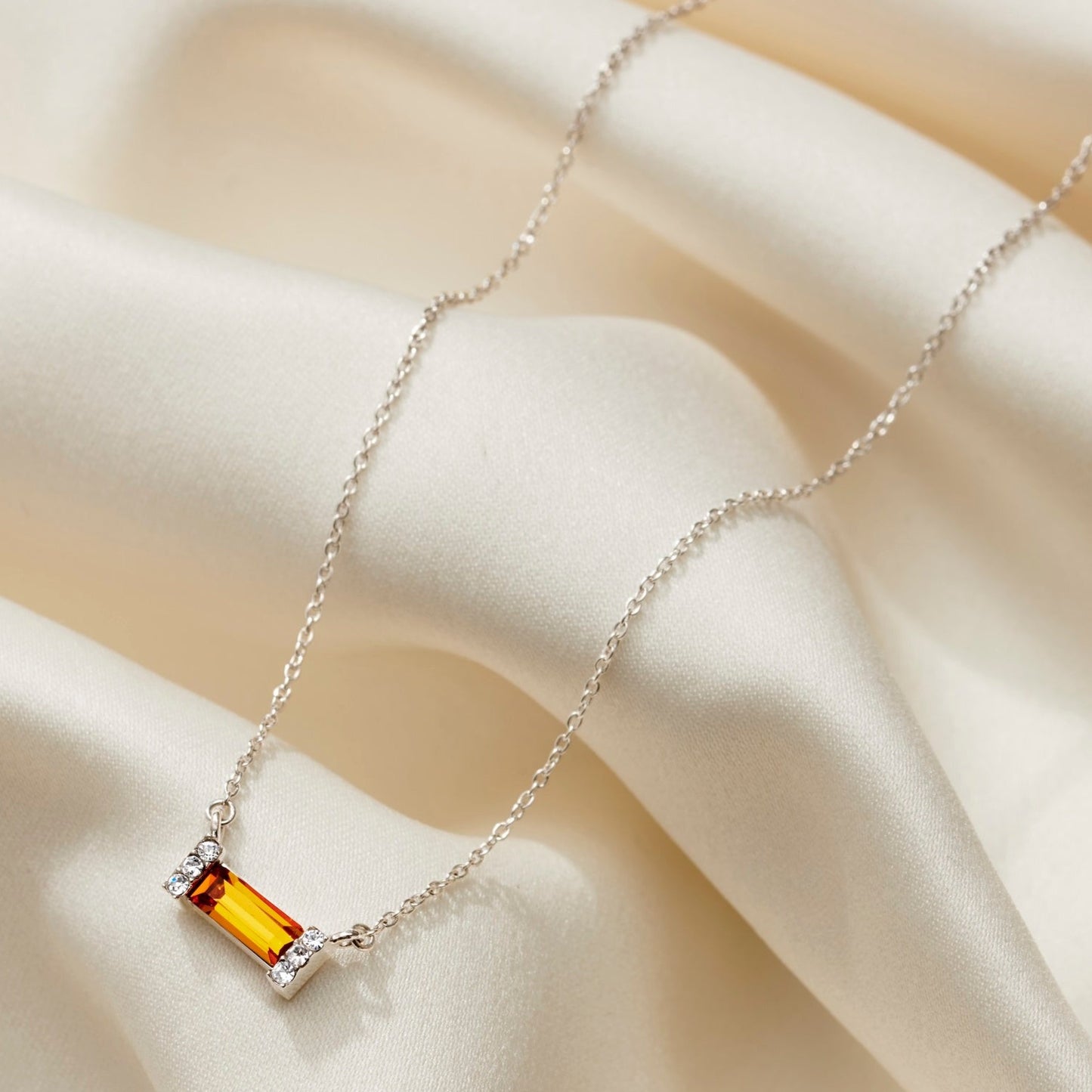 Yellow topaz baguette shaped crystal necklace with pavé setting on a dainty sterling silver trace chain.