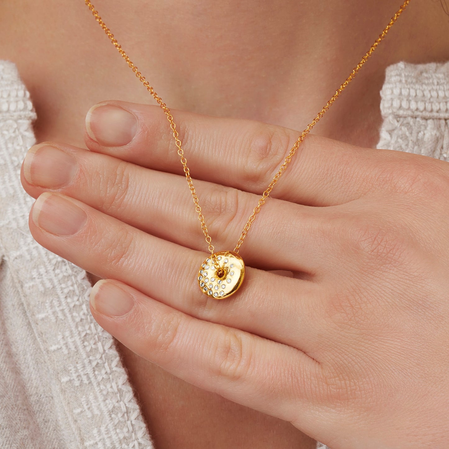 Claudette Worters gold vermeil Waxing Gibbous moon phase necklace with spinning disc pendant with a textured moon surface and small natural diamonds.