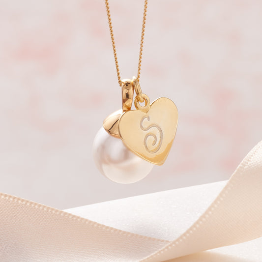 White pearl pendant necklace in gold vermeil personalised with heart initial charm on a fine gold chain