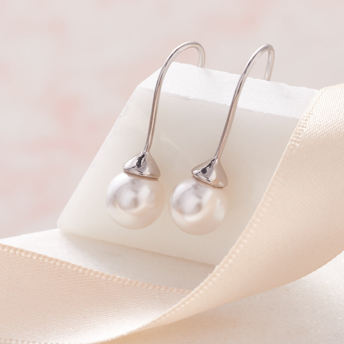 White pearl long drop earrings on a sterling silver hook fitting