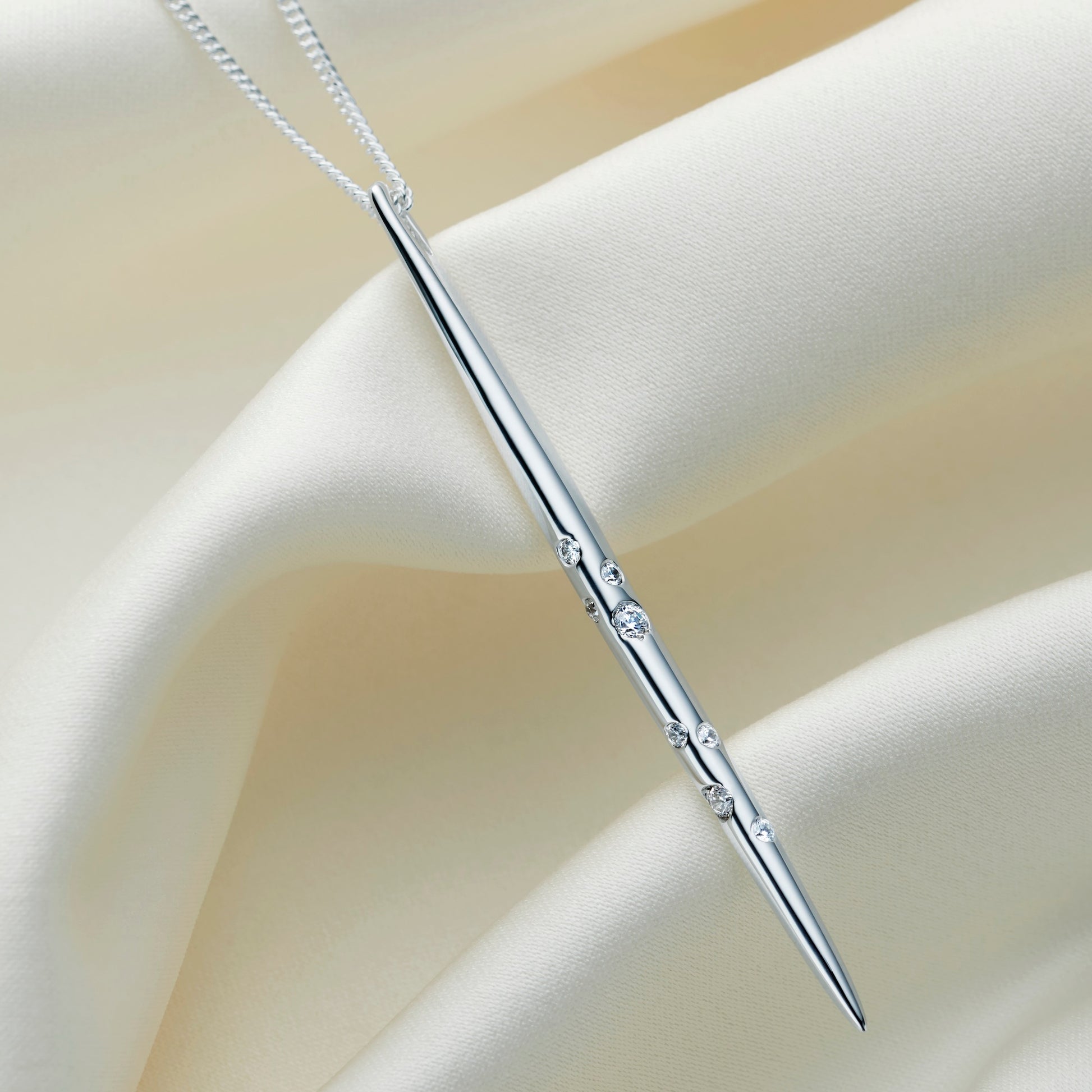 Sterling silver Sagittarius constellation necklace with a polished spike pendant set with Swarovski crystals, shown on an elegant silver chain.