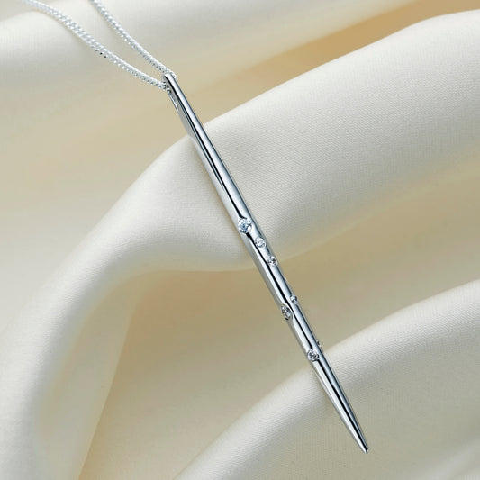 Sterling silver Scorpio constellation necklace by Claudette Worters, with a highly polished vertical spike pendant adorned with clear Swarovski crystals forming the Scorpio constellation, on a delicate silver chain.